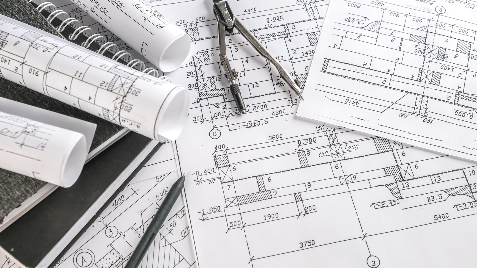 Engineering drawings, drafting compass, and rolled plans